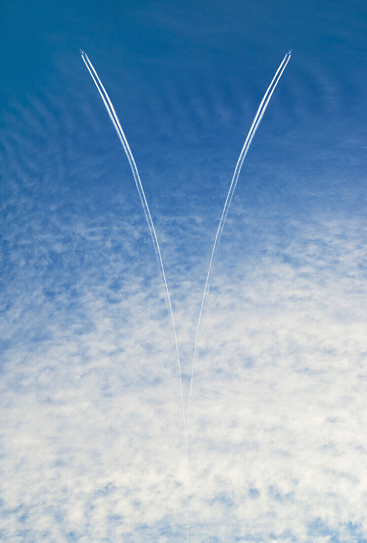 Two airplanes and vapor trails in the sky