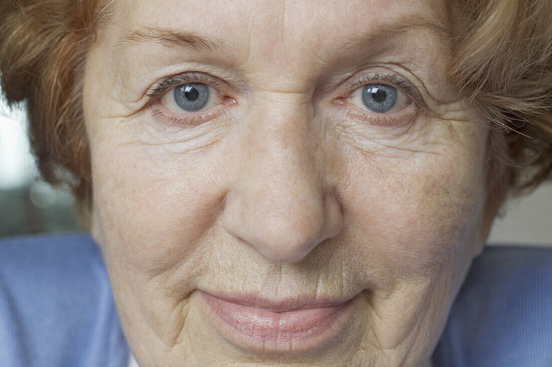 Close-up of a senior woman's face, looking at camera