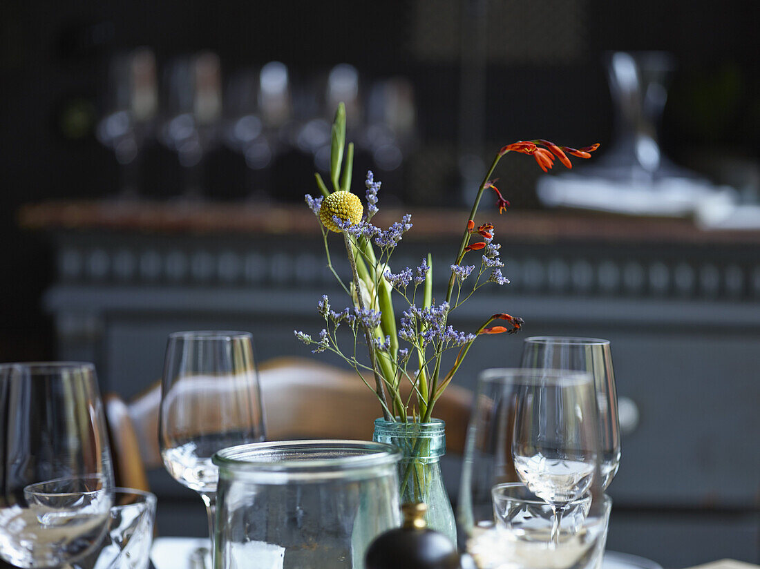 Flower vase and wineglasses in restaurant