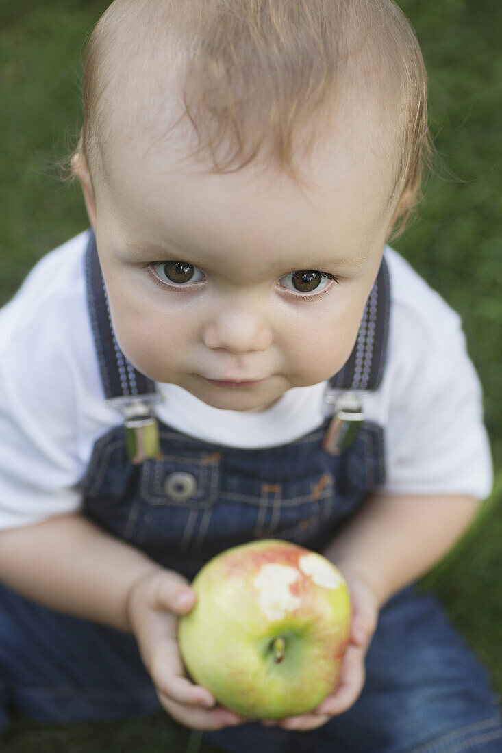 Baby holding apple