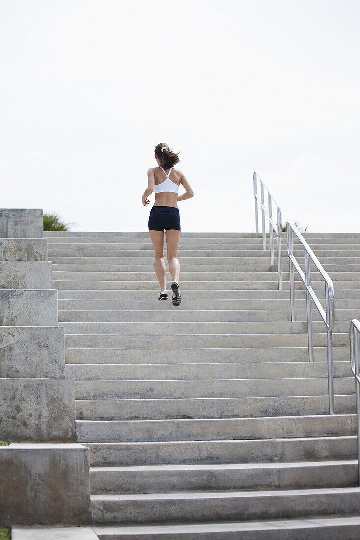 Girl jogging up steps