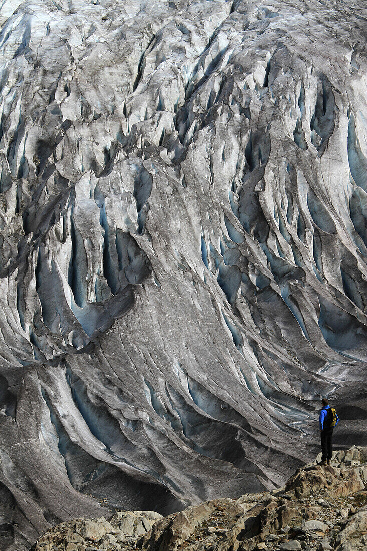 A man looking at the Aletsch Glacier, Valais Canton, Switzerland