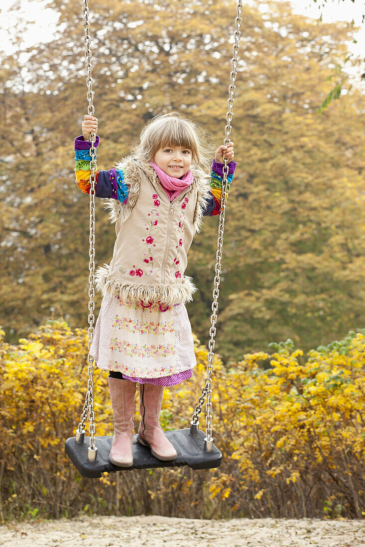 Girl on swing in park