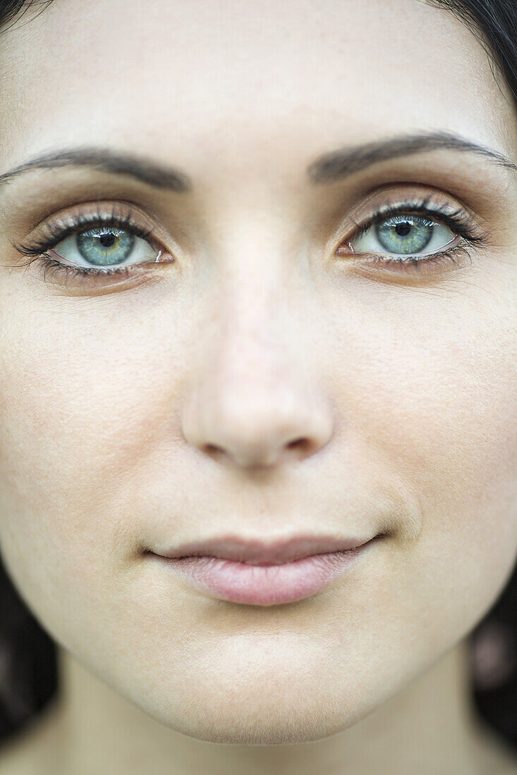 A beautiful woman staring serenely into the camera, close-up of face