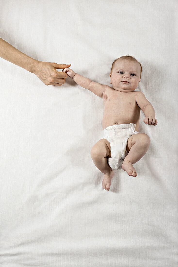 Child holding mother's hand