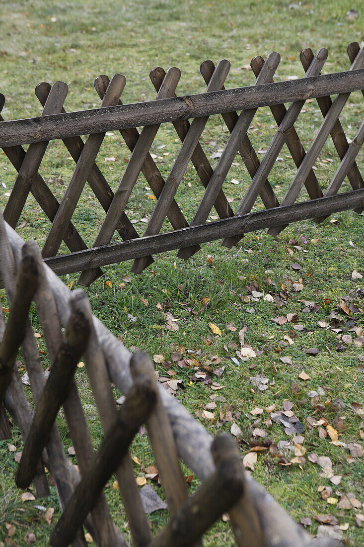 Crisscross wooden fence on grass