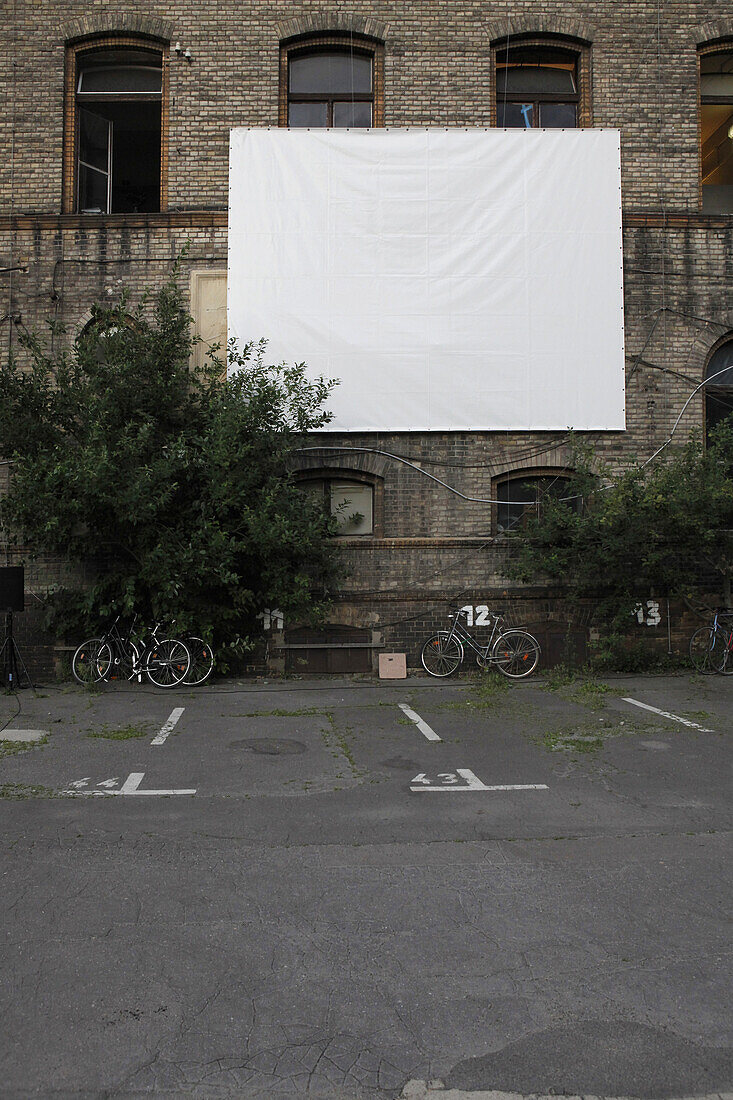 Projection screen in empty car park at Postfuhramt Building