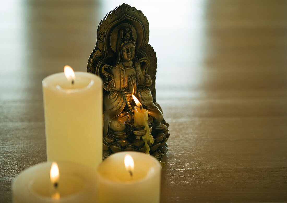 Candles and buddha statuette