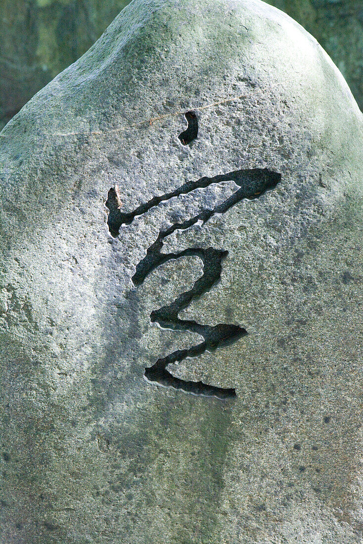 Japanese symbol carved into stone, close-up