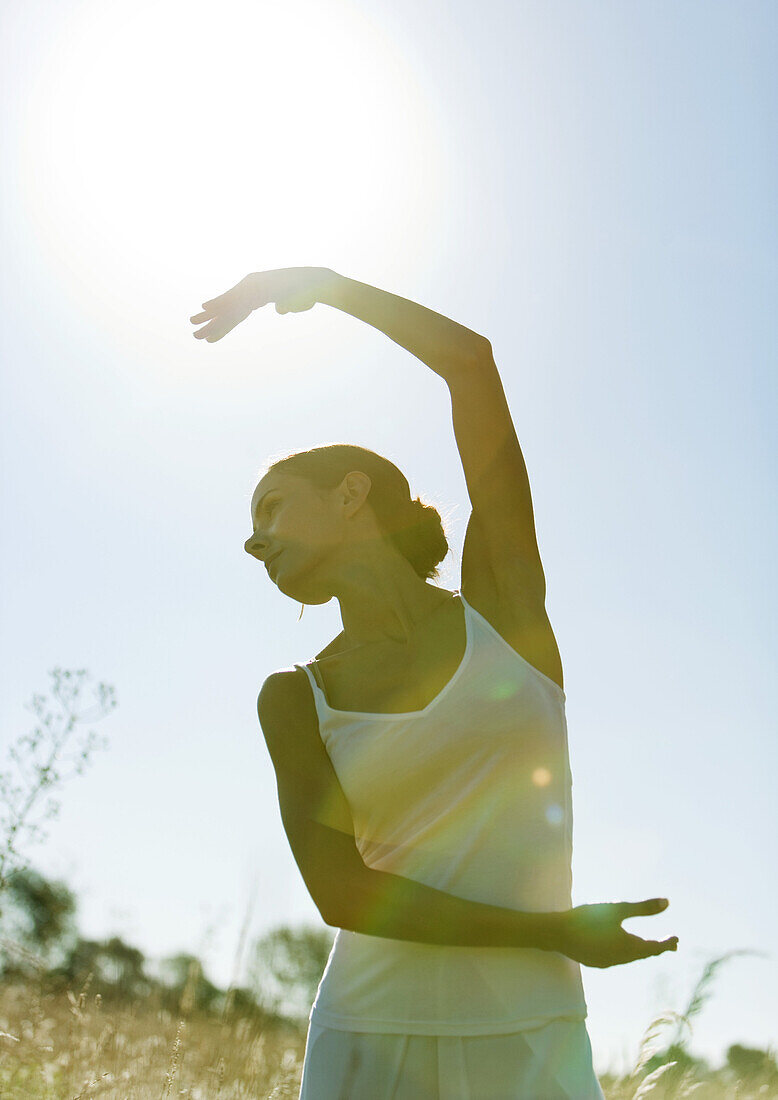 Woman dancing in field