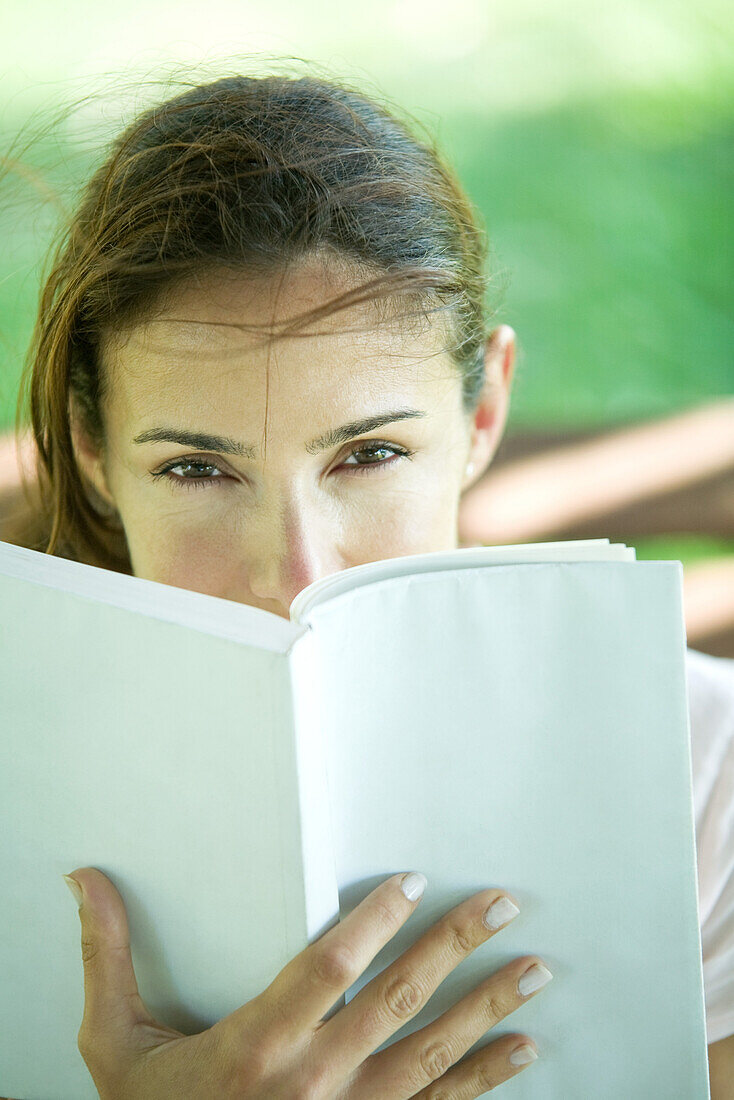 Woman looking over book