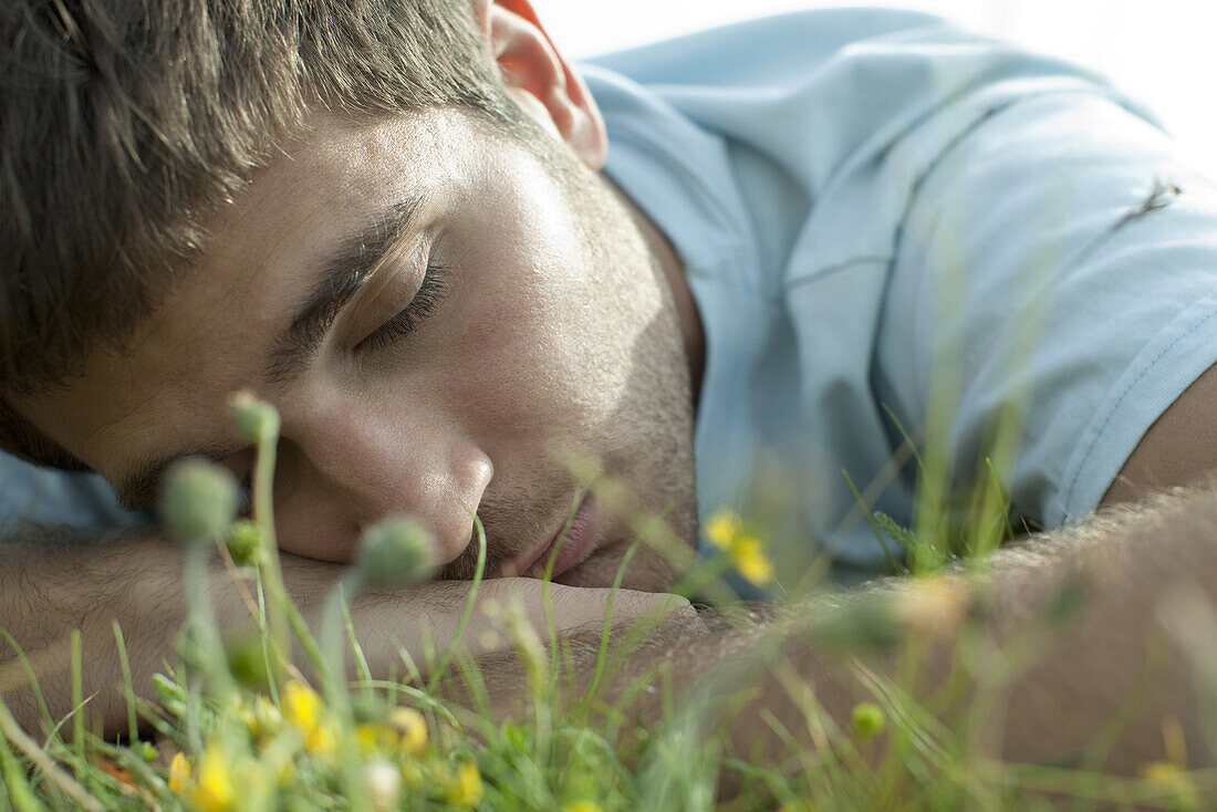 Man napping on meadow, close-up