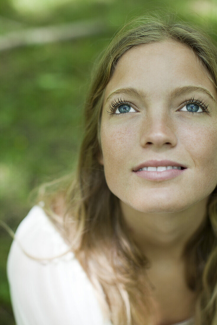 Young woman looking up, portrait