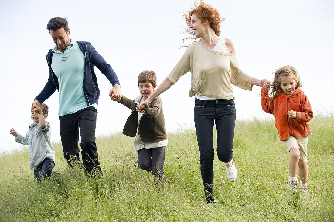 Family running together in field