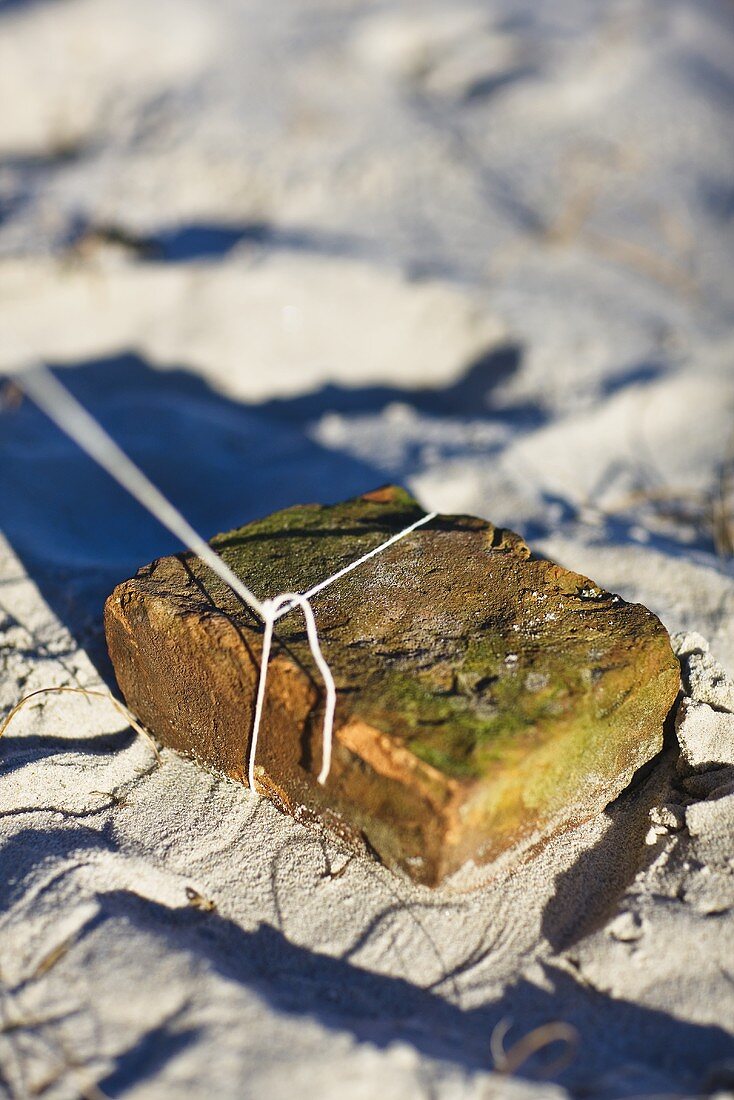 A brick in sand