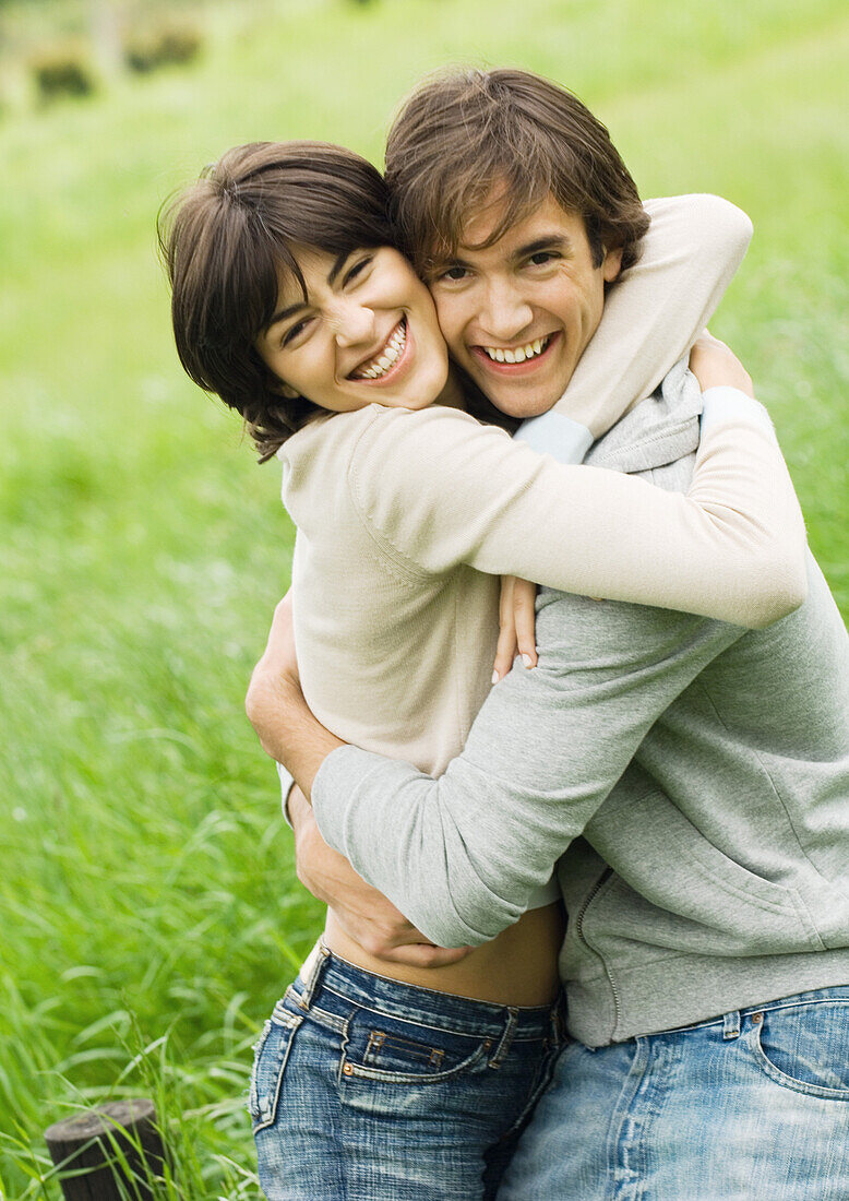 Young couple hugging and smiling