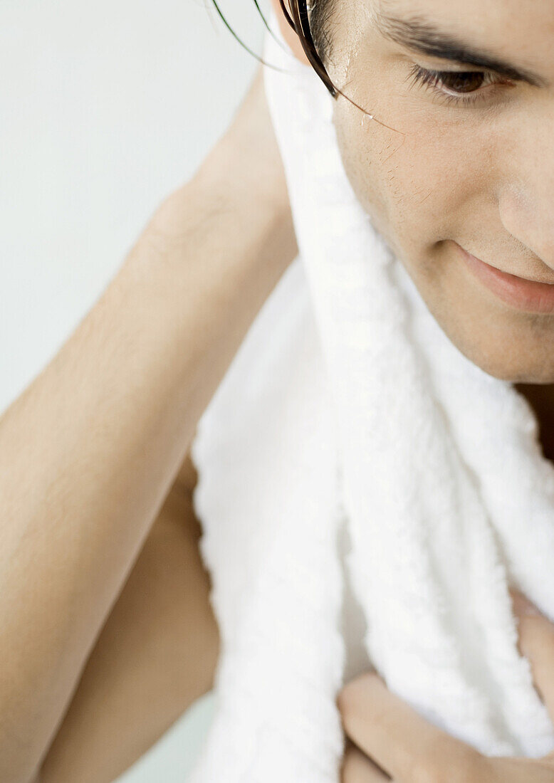 Man drying off with towel, cropped
