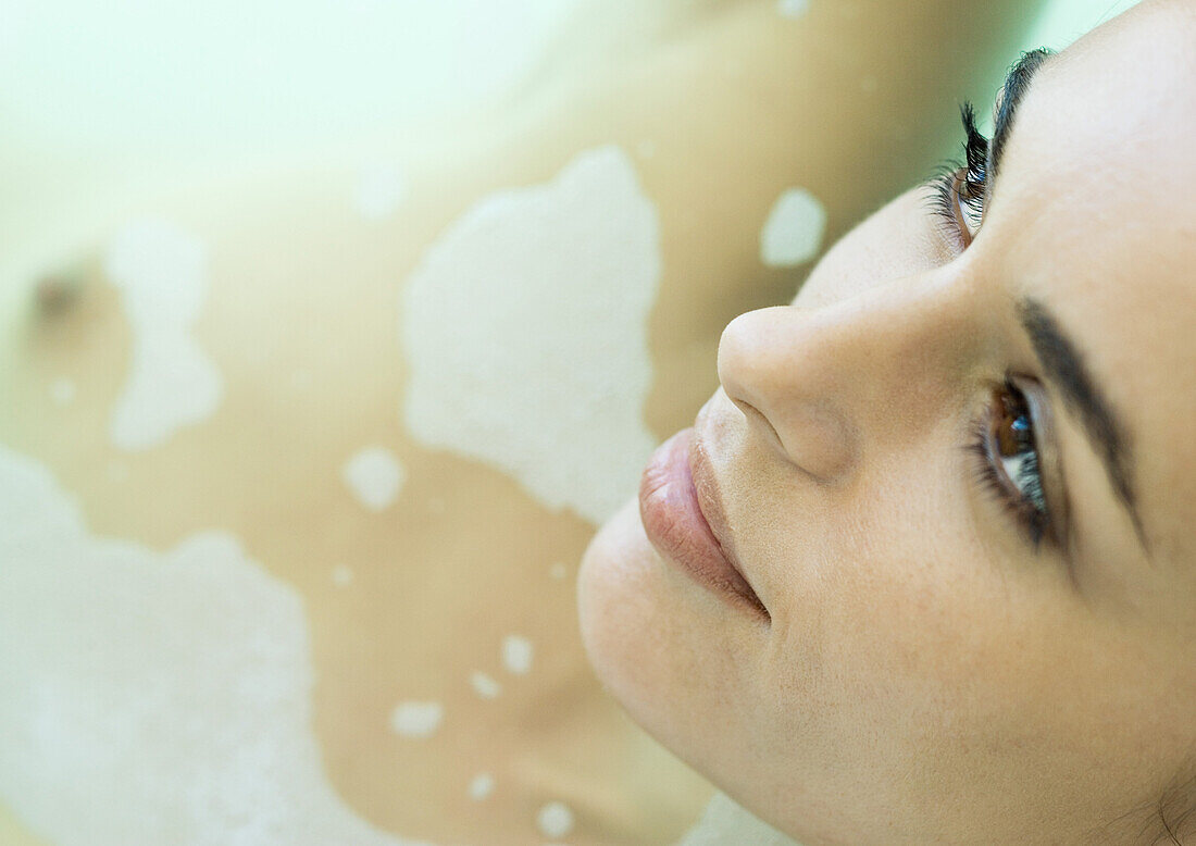 Woman in bath, close-up of face
