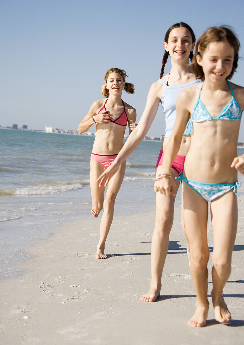 Girls running and walking on beach