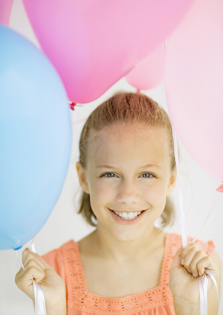 Girl holding balloons