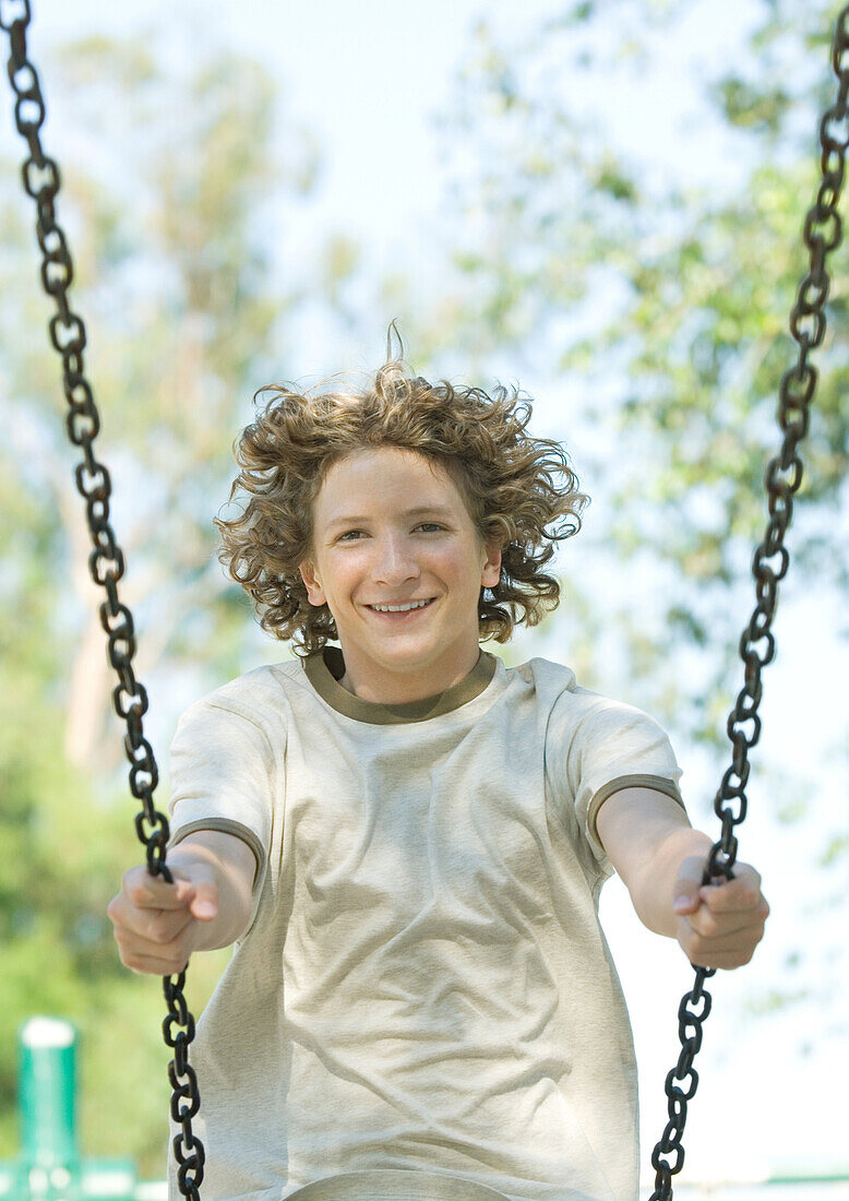 Teenage boy on swing