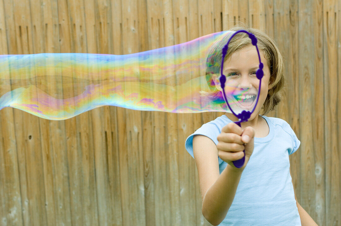 Girl making bubble with bubble wand