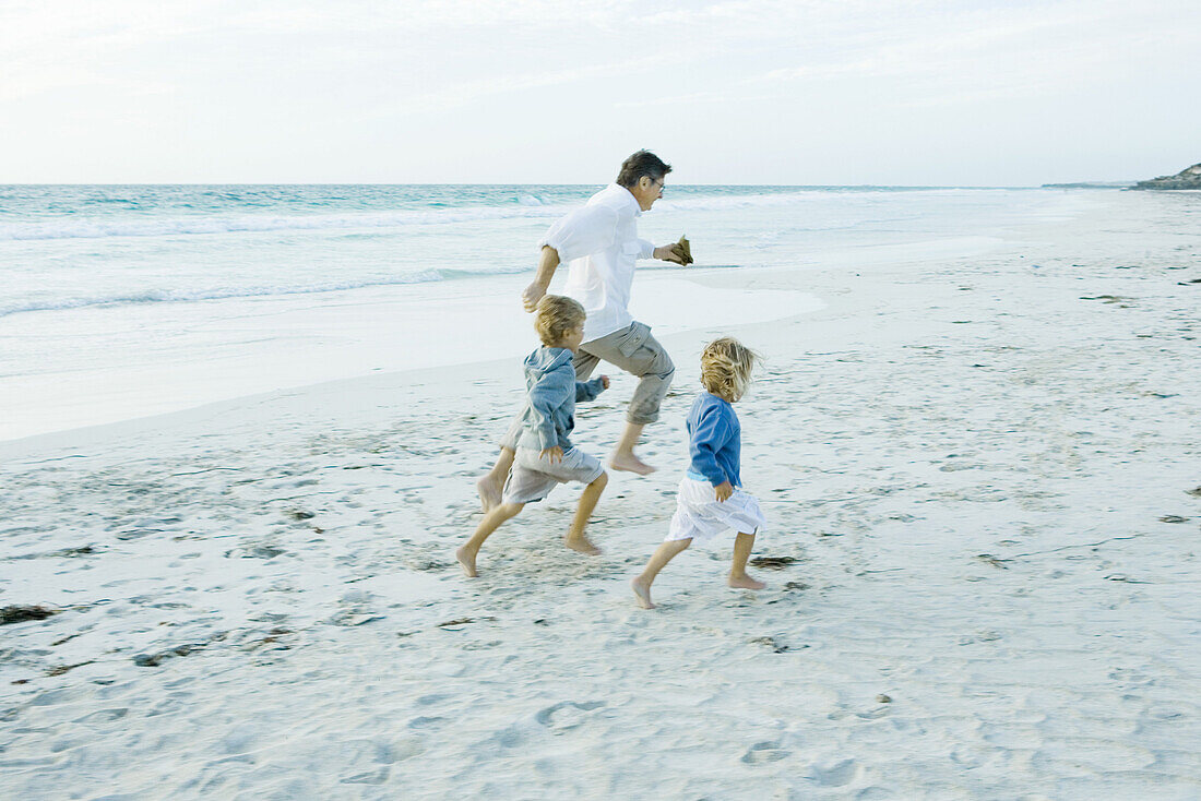 Family on beach, running