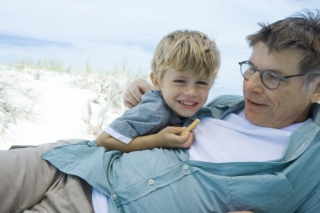 Boy and grandfather on beach