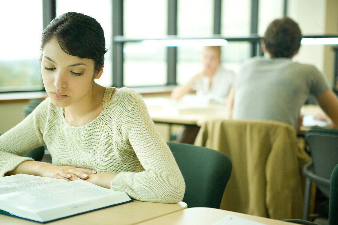 Young woman studying in university library