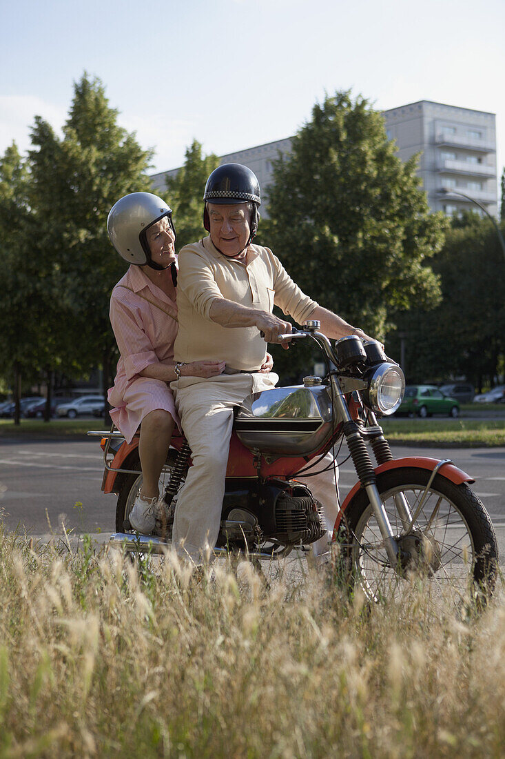 Senior couple happy on motorbike
