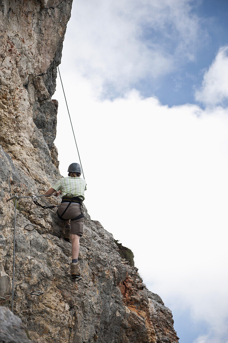 Person climbing rock face at The Wetterstein, Tirol, Austria