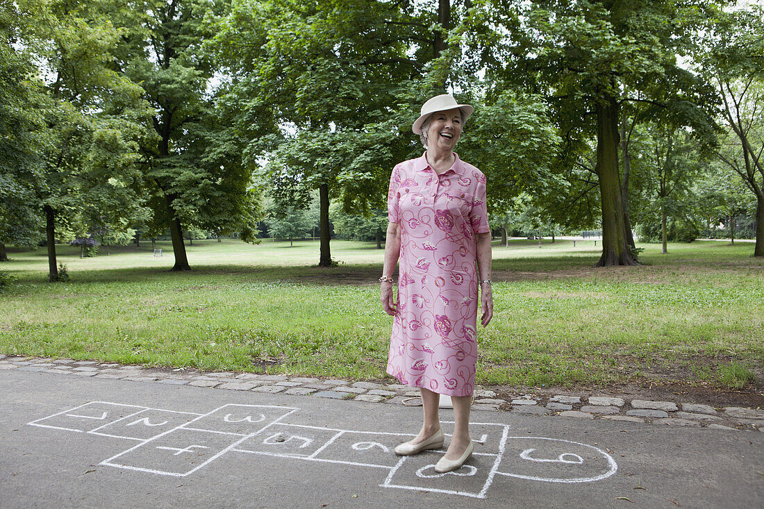 Woman standing on hopscotch markings