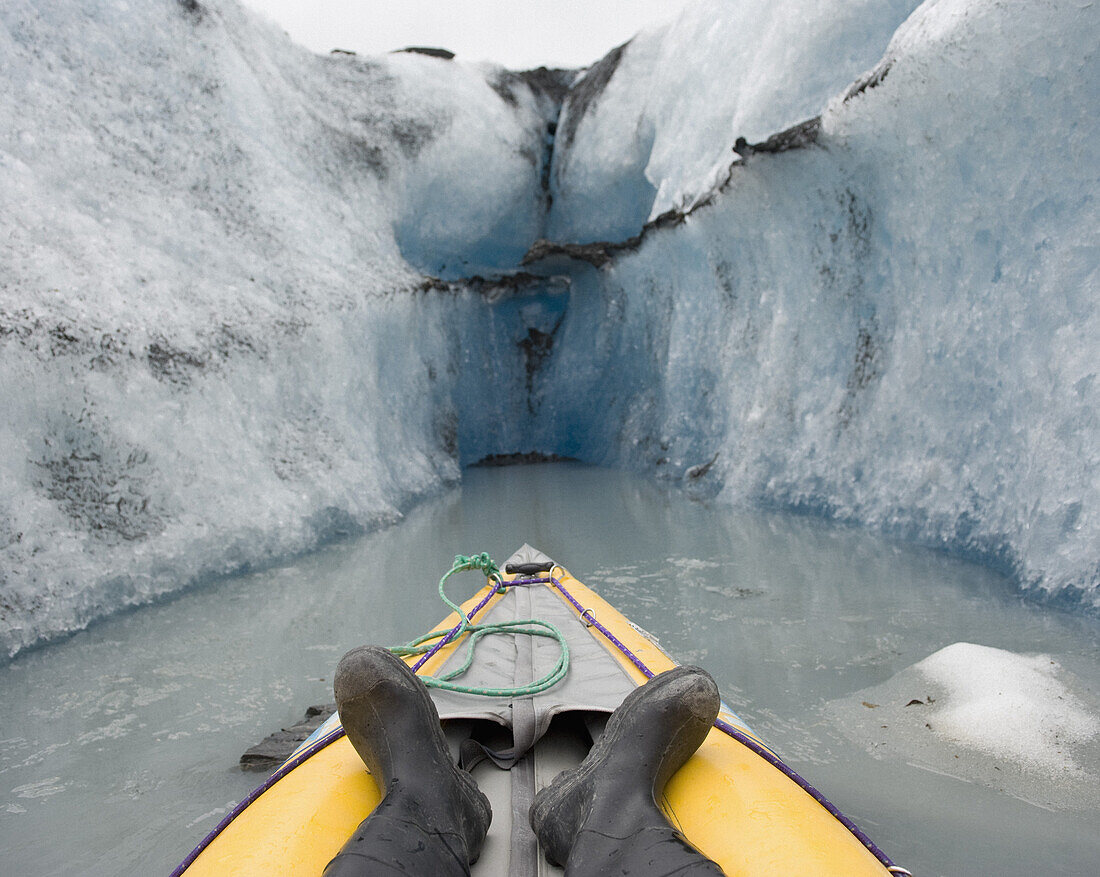 Kayaking between canal walls of Valdez Glacier, Alaska, USA