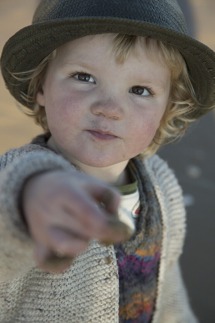 Portrait of cute boy showing dirty hands outdoors