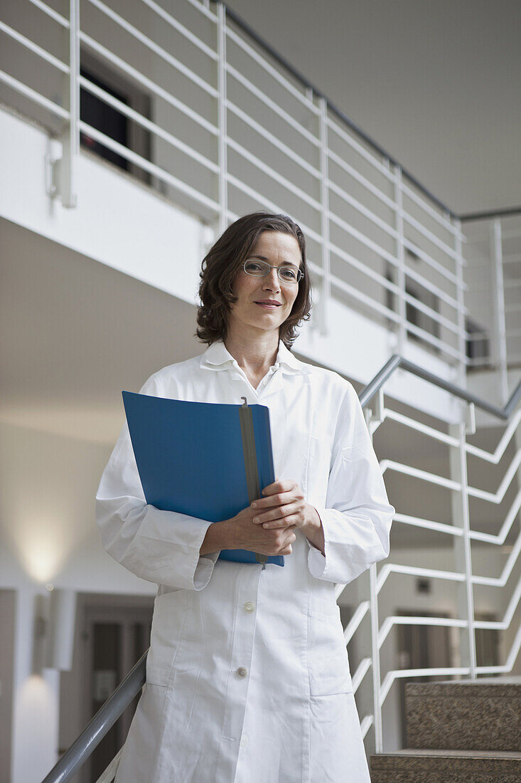 Portrait of a doctor holding a file