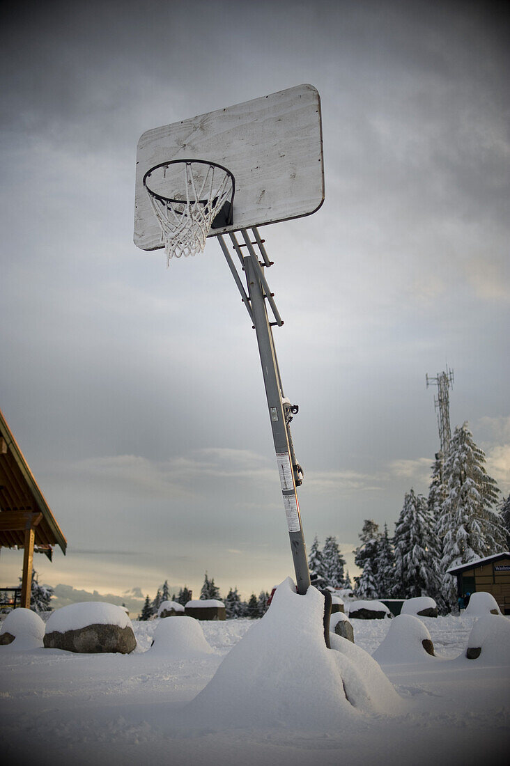 A basketball hoop in a snowy outdoor setting