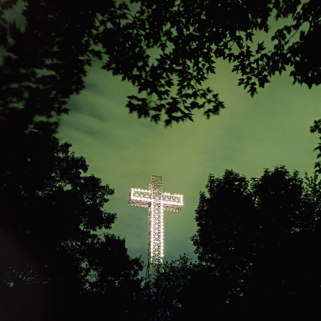 Illuminated Mont Royal Cross at dusk, Montreal, Quebec, Canada