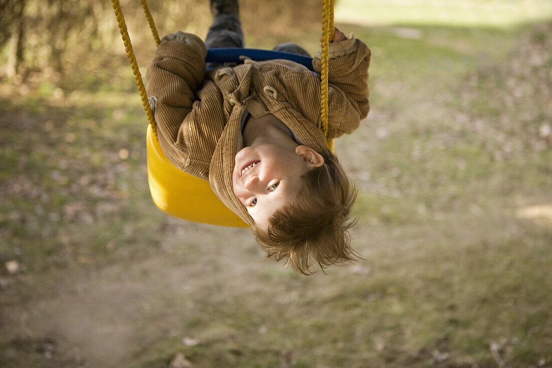 Baby girl swinging on swing, portrait