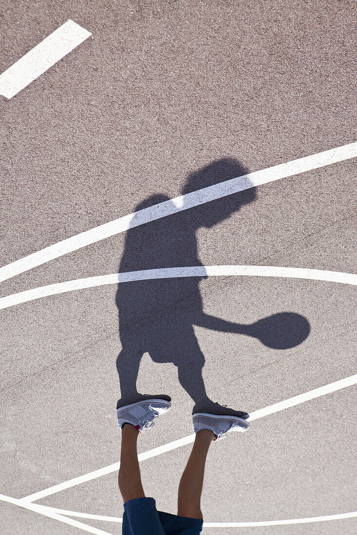 Man playing basketball, low section