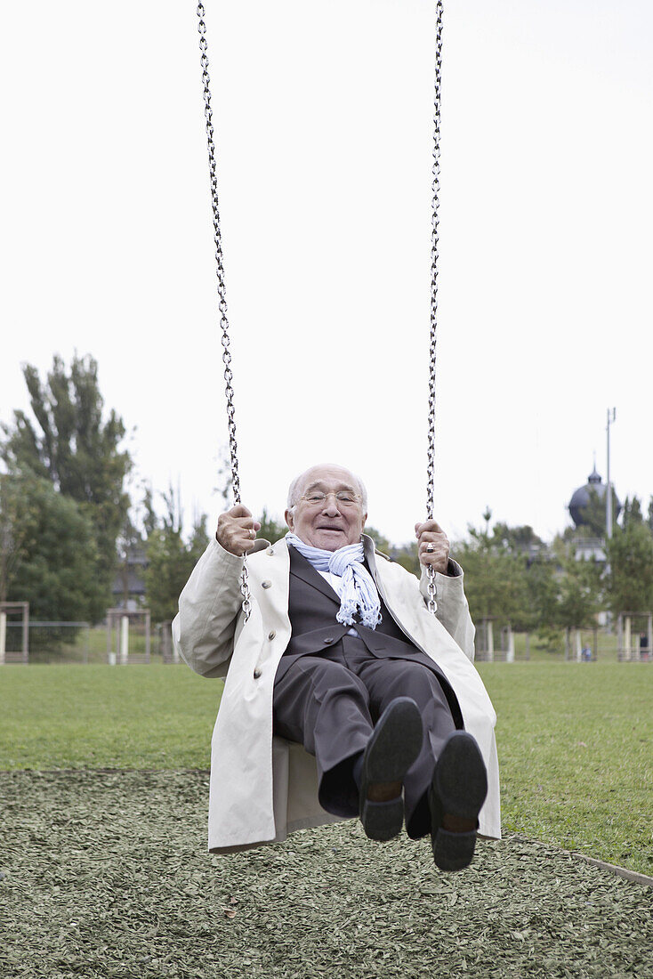 Senior man swinging in park