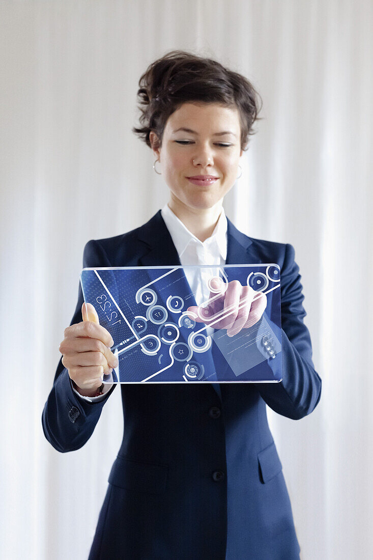 Portrait Of Smiling Businesswoman Using Futuristic Digital Tablet