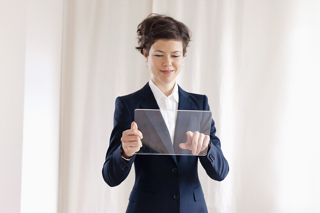 Happy Mid Adult Businesswoman Touching On Blank Transparent Digital Tablet