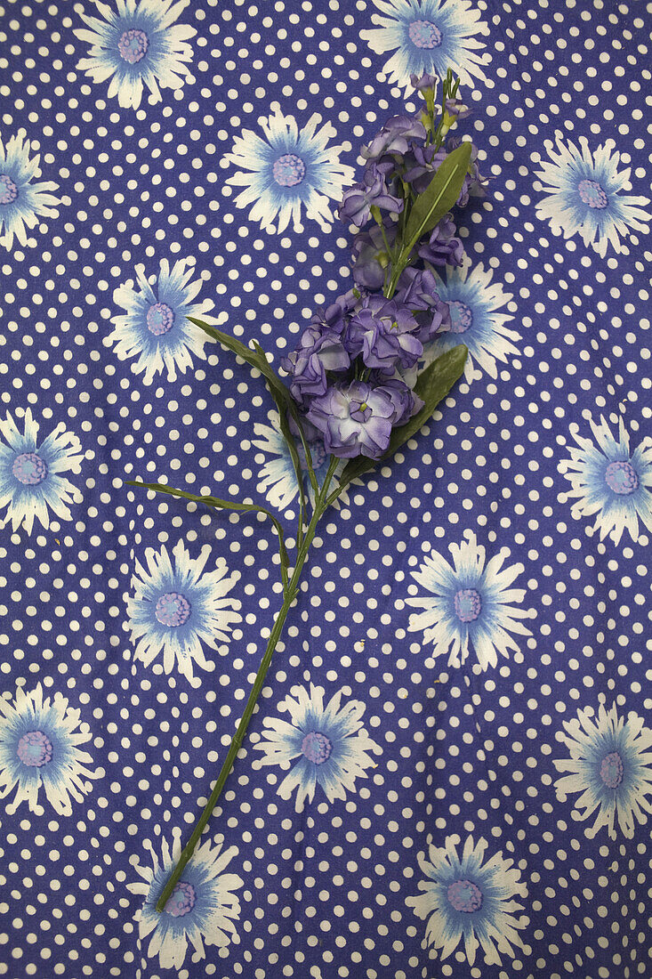 Purple flowers on floral fabric