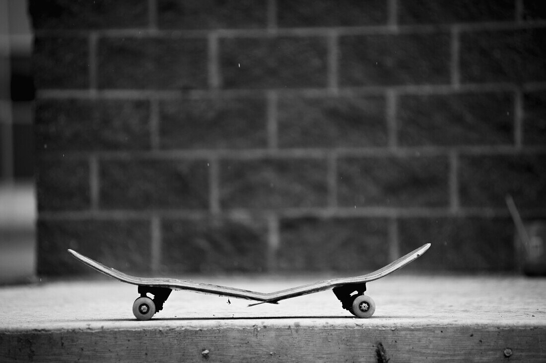 Broken skateboard on sidewalk