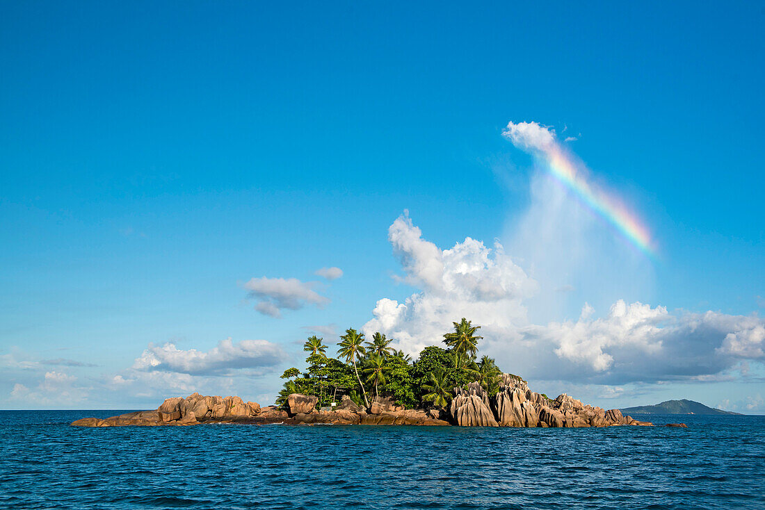 Island with rainbow, Sea kayak tour with catamaran as basecamp on the Seychelles, Indian Ocean