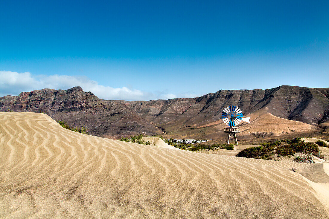 Windmill in front of Risco de Famara, Playa de Famara, Lanzarote, Canary Islands, Spain