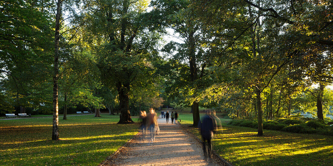 People walking through Schrevenpark, Kiel, Schleswig-Holstein, Germany