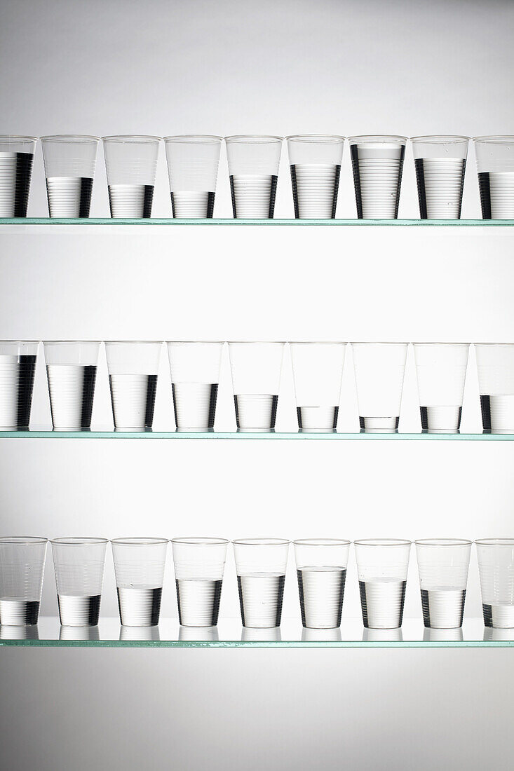 Rows of glasses filled with varying amounts of water