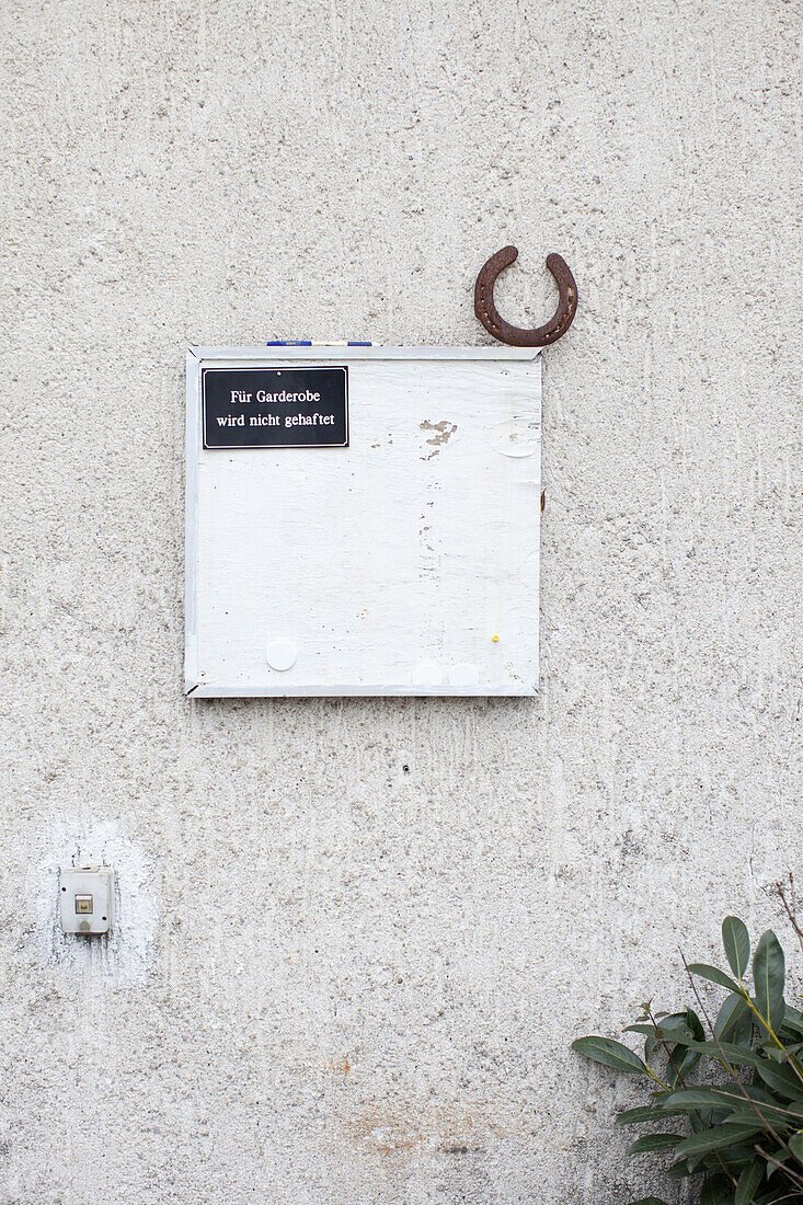 'A horseshoe and a sign hanging on a wall saying ''not responsible for belongings'''