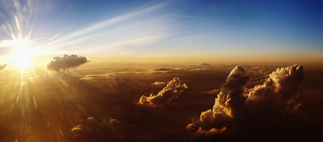 Sun rising on clouds, aerial view
